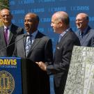 Gary S. May and Darrell Steinberg at podium adorned with ˽̳ Davis banner (with seal)