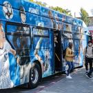 A bus decorated with photos of ˽̳ Davis athletes.