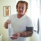 Matthew Treviño holds a canister of a hormonal birth control gel for men while in his home in Sacramento. He is part of a clinical trial at ˽̳ Davis Health testing the new drug. 