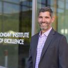 Ned Spang, associate professor of food science and technology, named new director of Robert Mondavi Institute. He stands in front of the institute's logo on a glass door. (Jael Mackendorf/˽̳ Davis)