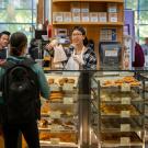 A barista serves a baked good at the Swirlz coffee area of the Coffee House in the Memorial Union at ˽̳ Davis.